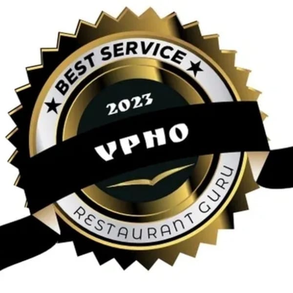 Gold and black 'Best Service 2023 vPho Restaurant Guru' award seal.